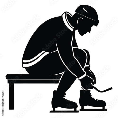 Silhouette of a skater sitting and tying ice skates preparing for the rink