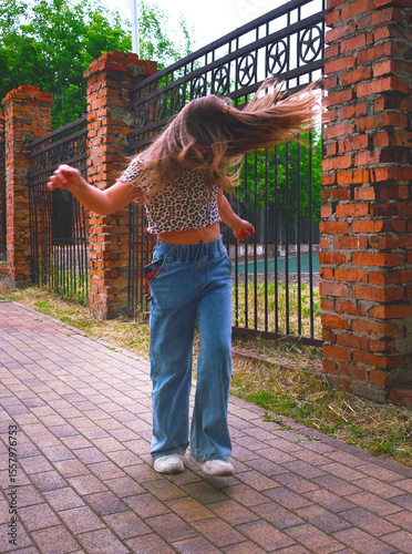 Happy young girl enjoying walking, dancing, jumping. Freestyle. Freedom and carefree. Individuality, alternative lifestyle. Activity summer vacations. Lifestyle photography. Blurred motion