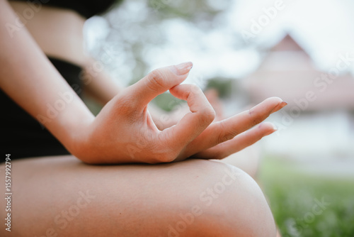 Wallpaper Mural A young Asian woman meditates outdoors for peace, mindfulness, and physical well-being. She feels calm, relaxed, and spiritually connected amidst nature. Torontodigital.ca
