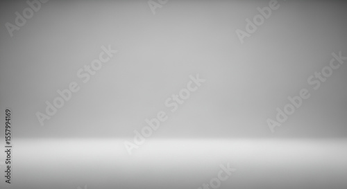 Empty gray studio room background with a smooth gradient for product display. Abstract minimalist backdrop with a clean, modern look.