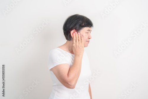 Elderly Woman having Ear pain for concept of Ear disease, Atresia, Otitis Media, Infection, Pertorated Eardrum, Meniere syndrome, Otolaryngologist, Hearing Loss, Hyperacusis, Tinnitus and Earwax