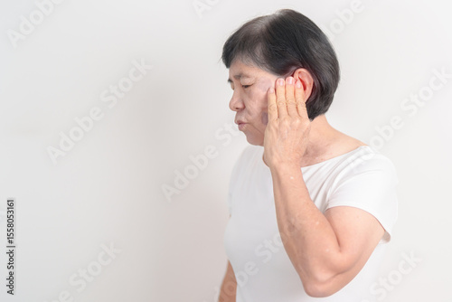 Elderly Woman having Ear pain for concept of Ear disease, Atresia, Otitis Media, Infection, Pertorated Eardrum, Meniere syndrome, Otolaryngologist, Hearing Loss, Hyperacusis, Tinnitus and Earwax