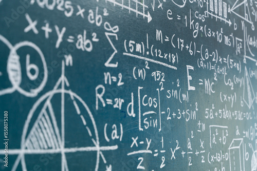 Close-up chalkboard with advanced math formulas, graphs, and scientific equations for education and learning concept