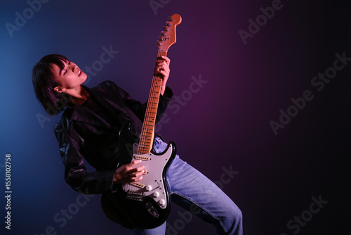 Cool young woman playing el...