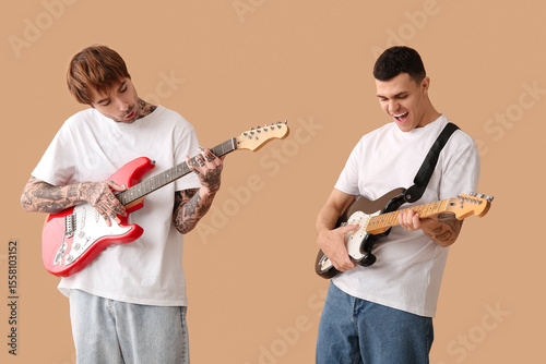 Cool young men playing elec...