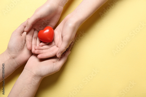 Red heart in cupped hands, ...