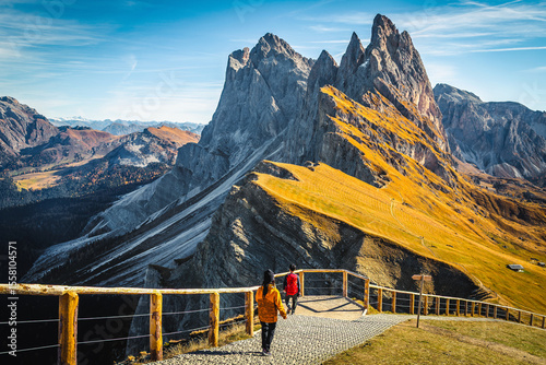 Beautiful viewpoint and hikers on the Seceda ridge, Dolomites, Italy