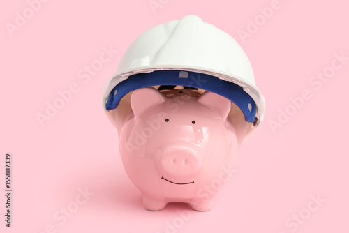 Piggy bank in hardhat on pi...