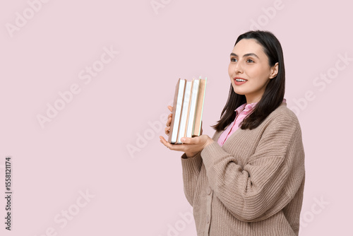 Young woman holding books o...