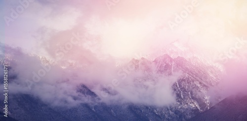 Photography Clouds covering snowcapped mountains against sky