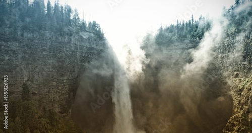 Flat design waterfall scene is showing backlit cascade plunging into canyon, with evergreen trees