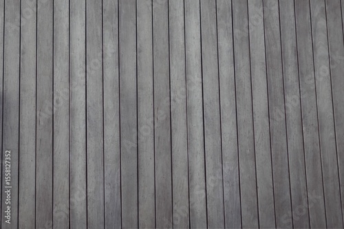 Vertical wooden planks are showing natural grain and knots in flat design texture pattern