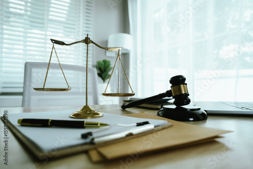 Lawyer sitting at desk in modern office reviewing and signing legal documents related to finance, equity and contractual agreements in business law.