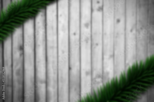 Blurred fir branches on wood