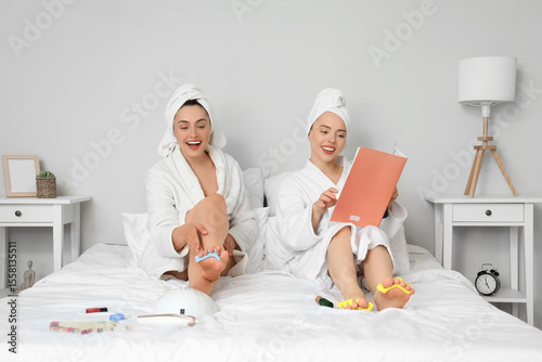 Young women in bathrobe wit...