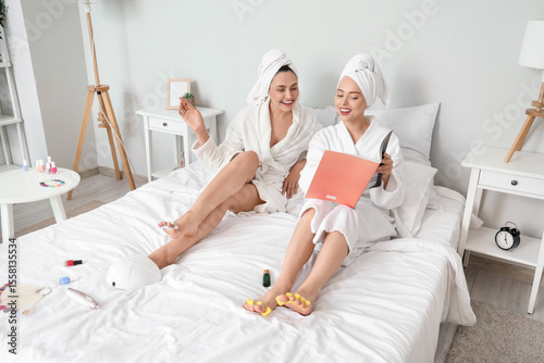 Young women in bathrobe wit...