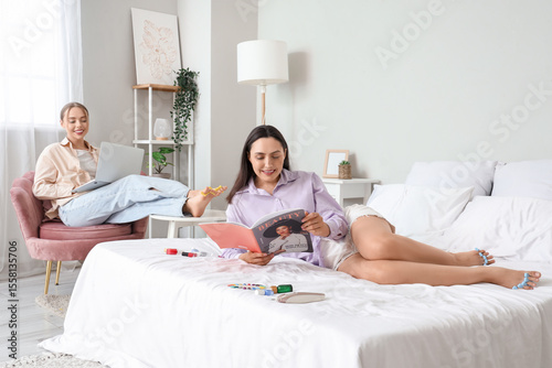 Young women with laptop and...
