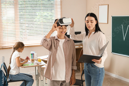 Teenage boy in VR glasses a...