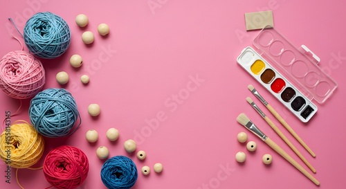 Wallpaper Mural Craft supplies on pink colorful yarn, wooden beads, watercolor paints, brushes. Essential art and craft materials for creative hobbies, DIY projects. Torontodigital.ca