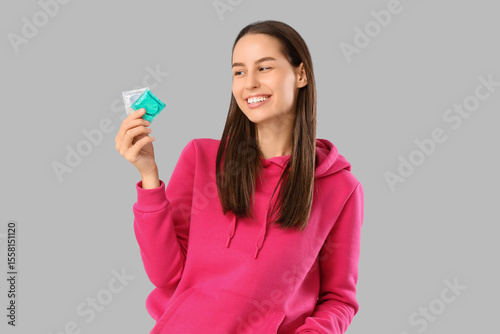 Young woman with condoms on...