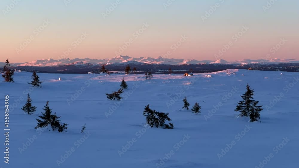 Arctic winter powder golden hour vibrant sunset top of Øyer mountain peak terrain Lillehammer Hafjell Alpine resort remote frozen snowy landscape pine trees deep powder Norway Norge Sjusjoen pan left