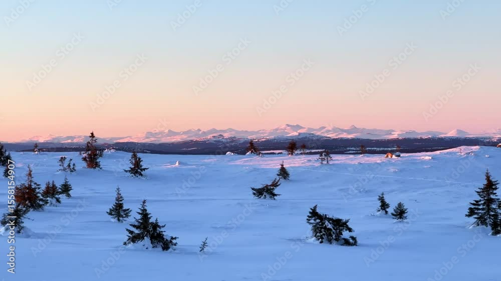Øyer mountain peak arctic winter terrain Lillehammer Hafjell Alpine resort remote frozen snowy landscape powder golden hour vibrant sunset top of pine trees deep powder Norway Norge Sjusjoen pan right