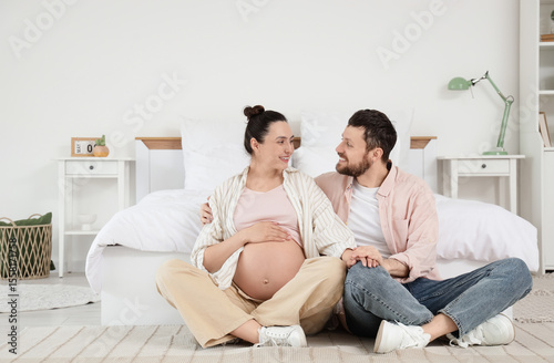 Happy pregnant couple huggi...