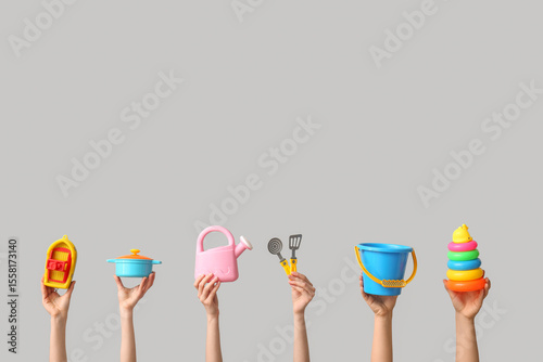 Hands holding baby toys on ...