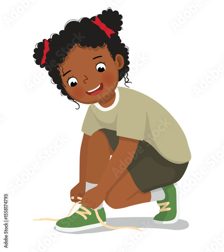 Little African girl tying her shoelaces
