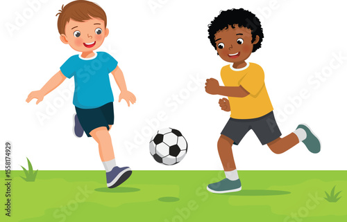 Little kids playing soccer football together in the field