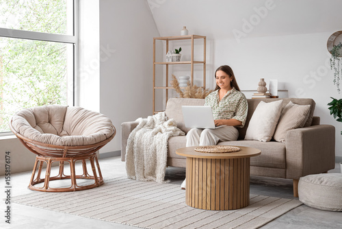 Beautiful young woman using...