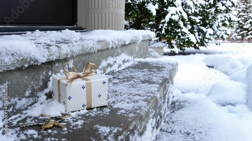 Snowy doorstep with a gift and keys, winter scene