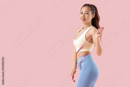 Sporty young Asian woman wi...