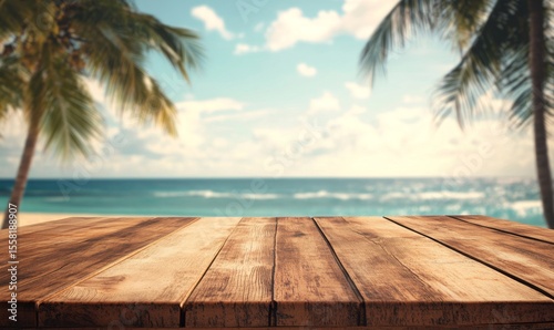 Wooden table sitting on top of a beach next to the ocean, surrounded by lush plants and trees. The sky is filled with white, fluffy clouds, creating a peaceful atmosphere.