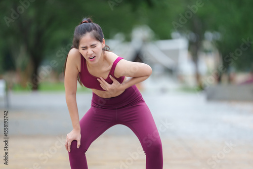 Tablou pe pânză Young sporty woman suffering chest pain after exercising outdoors