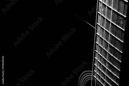black acoustic guitar on a black background, silhouette. black and white, close-up
