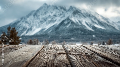 Winter Majesty Wooden deck view of snowcapped mountain range.