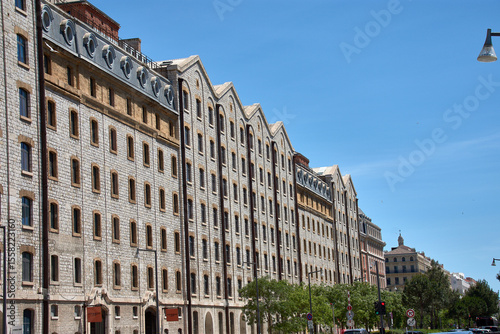 Stone facade of Les Docks in Marseille, France, a former port factory restored as a modern commercial and business center