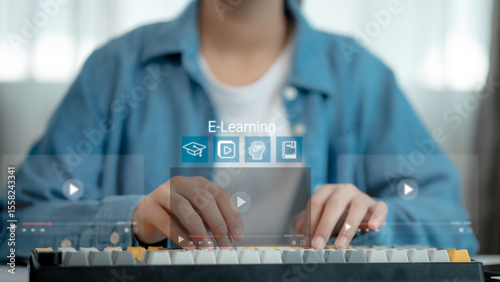 Close-up of hands typing on keyboard with virtual e-learning interface and online video icons, representing digital education, online training, virtual class, and modern learning technology.