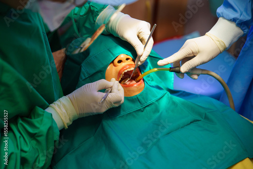 Dentist at work or Concentrated specialist removing tooth stone from client's teeth using ultrasonic scaler. Professional painless teeth cleaning at modern dental