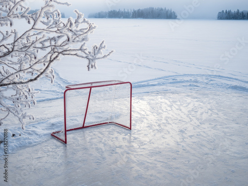 Photography Hockey goal on a pond hockey rink on frozen lake