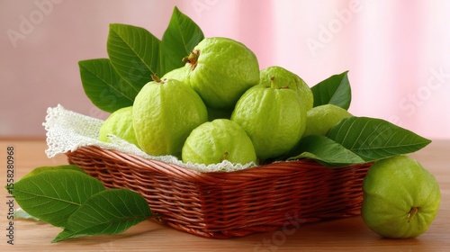 Guavas with leaves in brown basket, clean bright background with summer freshness