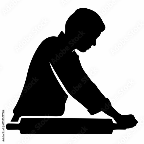 Silhouette of a person rolling dough with a rolling pin on a flat surface in a black and white image