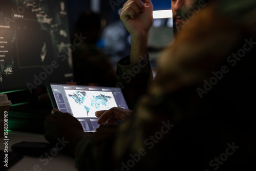 Army officers managing air traffic control using radar surveillance software on tablet. Close up of military agents following enemy units on reconnaissance satellite system using device