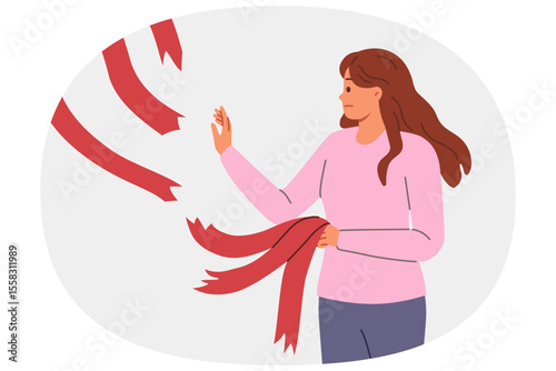 Woman breaking old ties in form of ribbons hanging from above, for concept of ending relationship with toxic friends. Breaking ties to get rid of narratives that negatively affect career growth