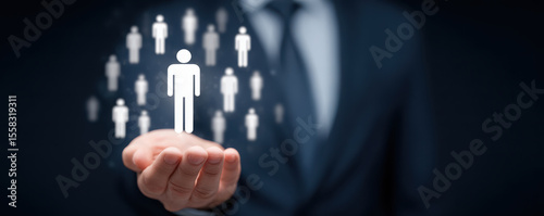 Businessman holding digital icons of people and team symbol with blurred background