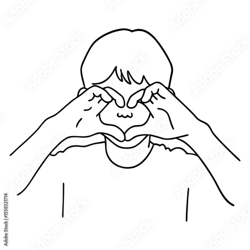 boy making heart shape with hands as symbol of love or kindness