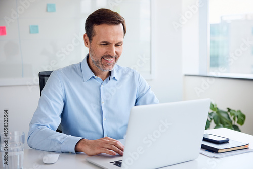 Businessman working on laptop at office