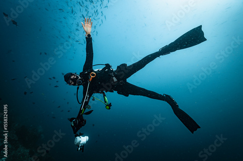 diver descending into the tropical water at Raja Ampat