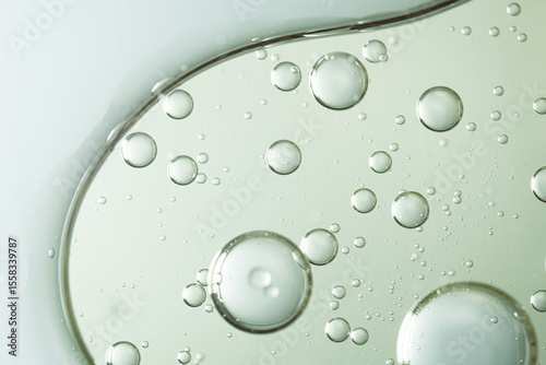 A macro abstract image of oil bubbles suspended in clear liquid, evoking facial serum texture. Ideal for beauty, cosmetic, and skincare-themed visuals.